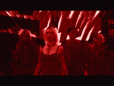 Still from the Matrix video: a girl in a red dress in front of a red scribbled backdrop, a crew in black behind her